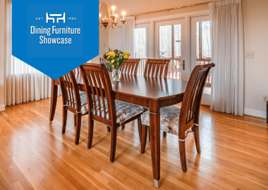 Dark wood table with 6 dining chairs in minimalist dining room with warm wood floors.