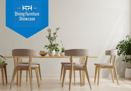 Minimalist dining room with oak-colored wood table and mid-century chairs. There are plants on the table and as decor in the room.
