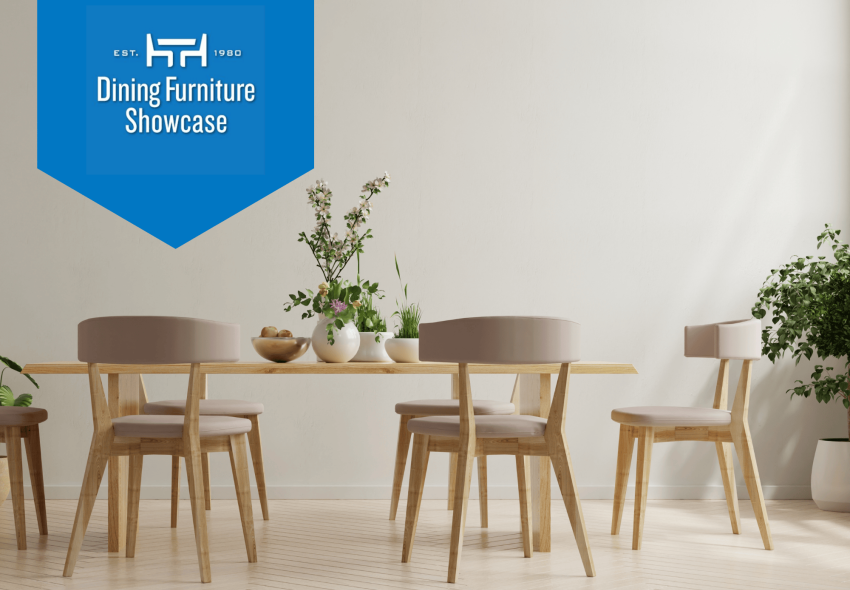 Minimalist dining room with oak-colored wood table and mid-century chairs. There are plants on the table and as decor in the room.